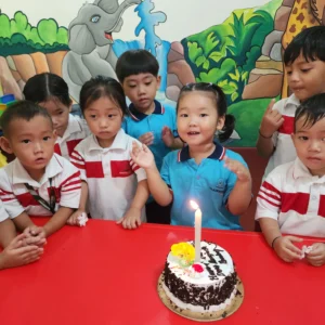 Kids cutting colorful birthday cake at BrainBunny Juniors