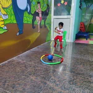 Preschool kid playing with ball in indoor activity