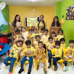Preschool teachers guide children in colour theme activities during Yellow Day celebration